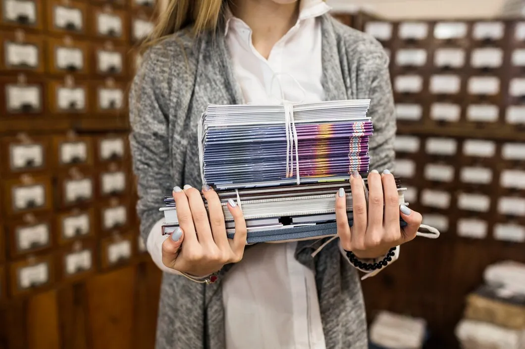 crop-woman-with-stack-books-copy